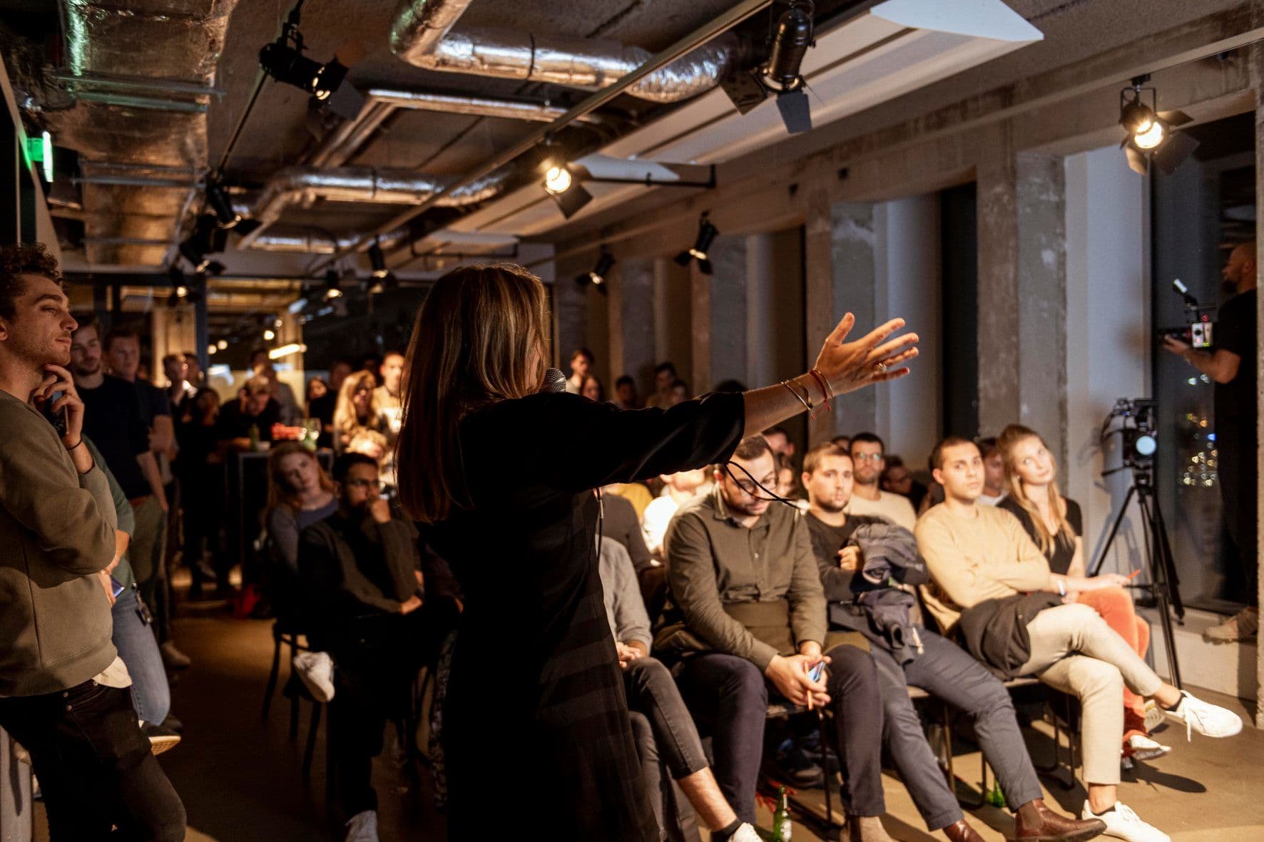 The Swarm community event — speaker presenting to a crowd of builders